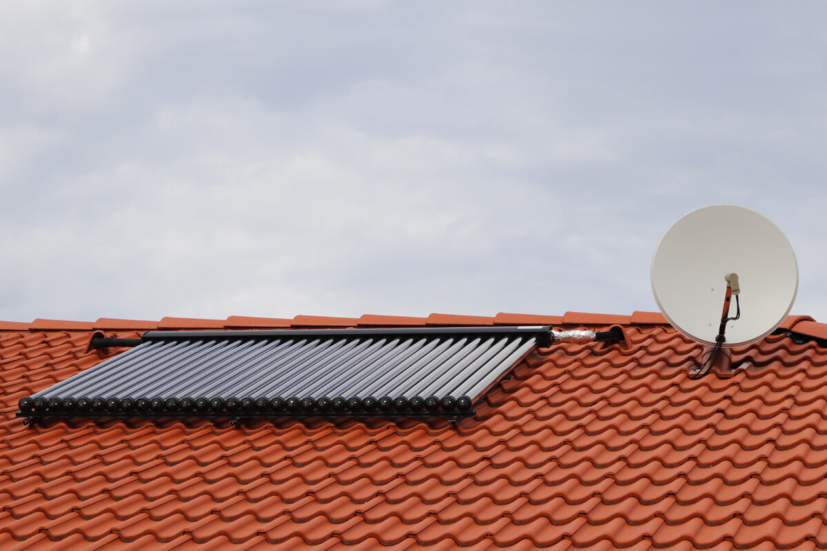 A roof fitted with a solar thermal panel, illustrating a renewable energy installation for solar water heating systems.