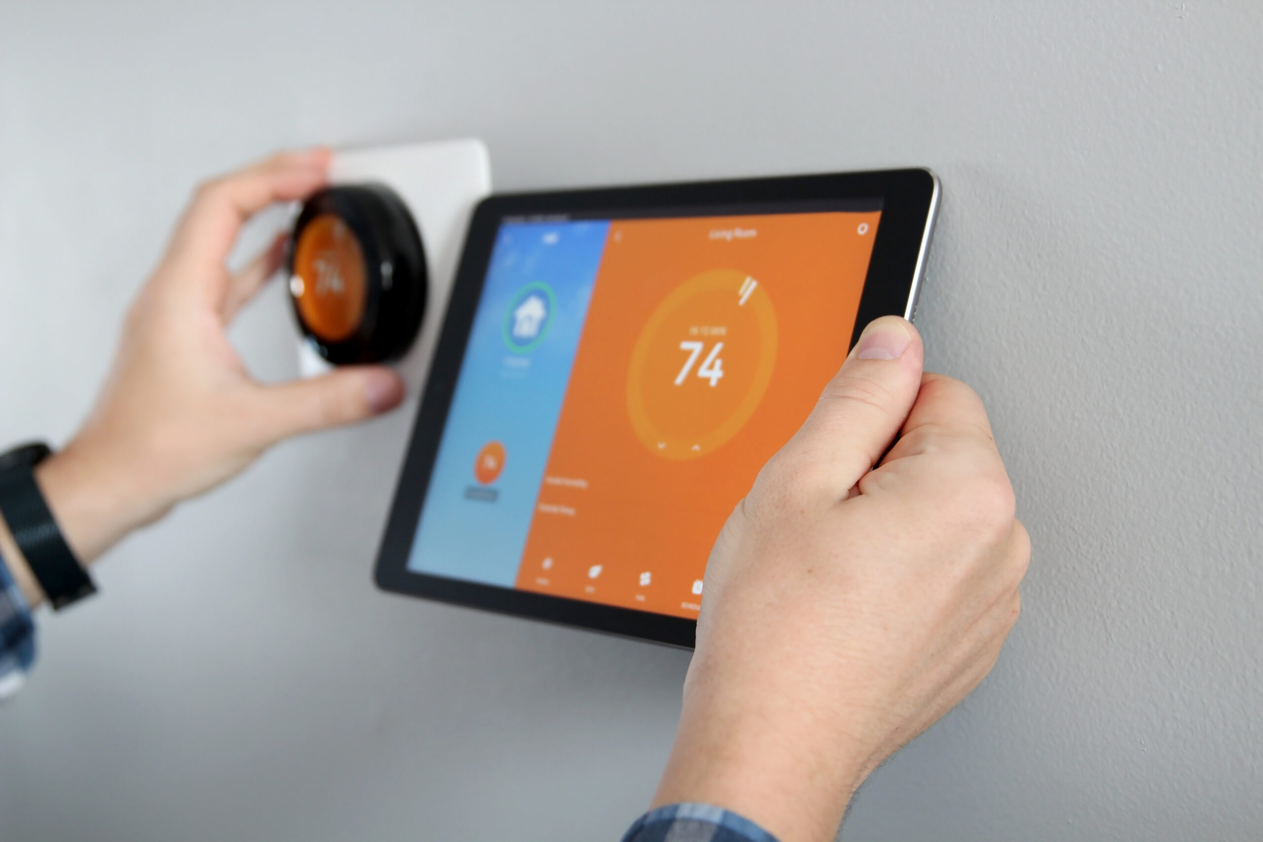 Man is Adjusting a temperature using smart heating controls.